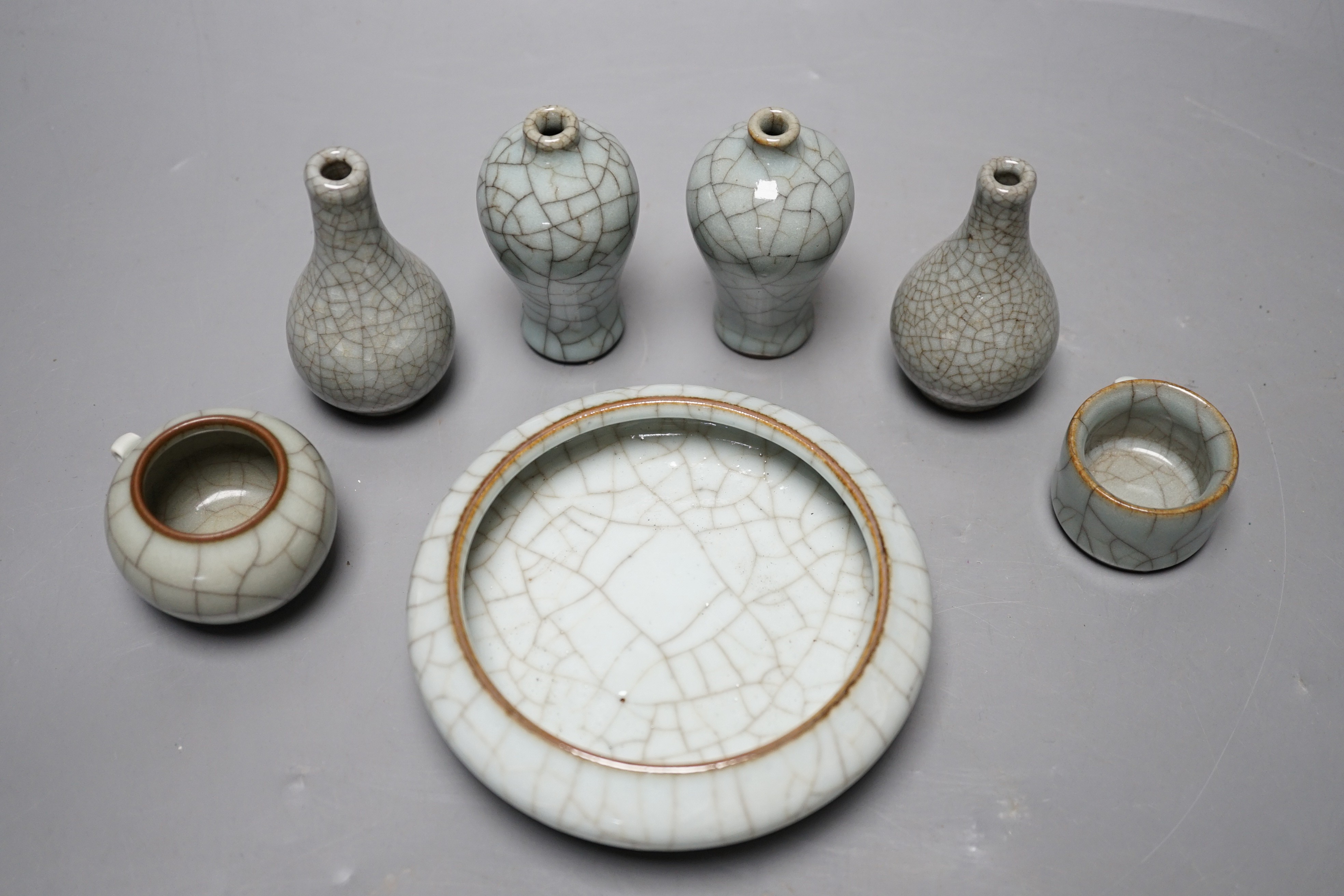 Seven Chinese Guan-type crackle glaze vessels one with four character mark, largest 11cm diameter